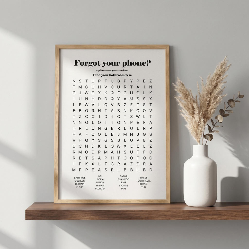 White bathroom word search print in a wood frame