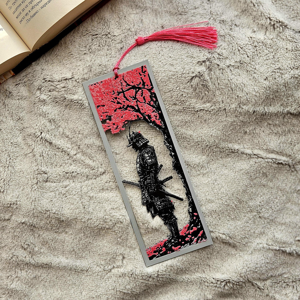 Decorative bookmark with a black and red design on a textured surface