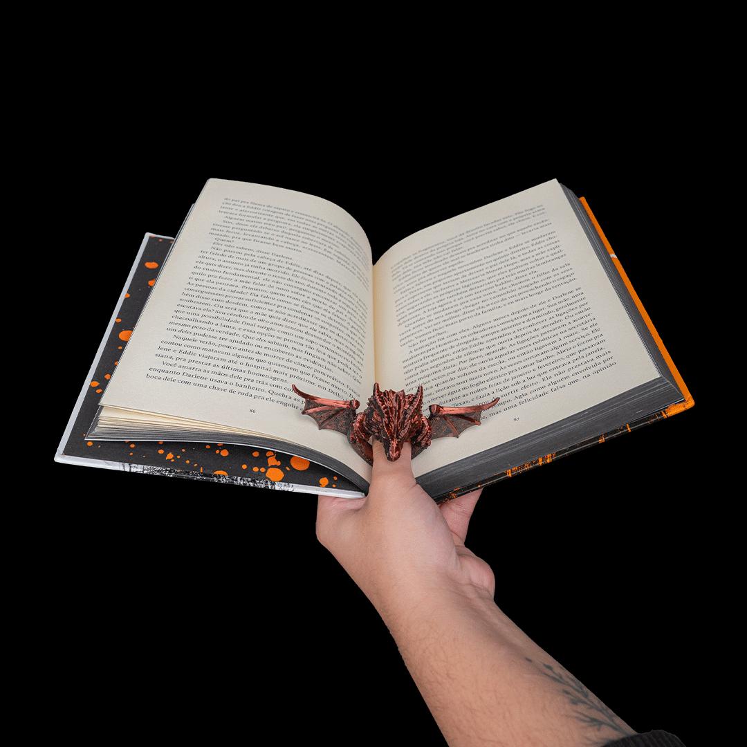 Holding an open book one-handed with the dragon page holder