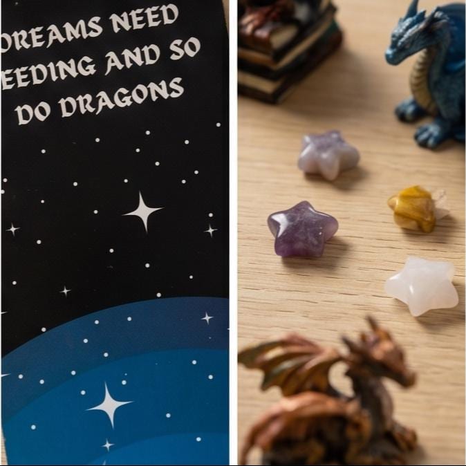 Close-up of the Dreams need feeding and so do dragons bookmark, beside small dragon figures and crystal stars