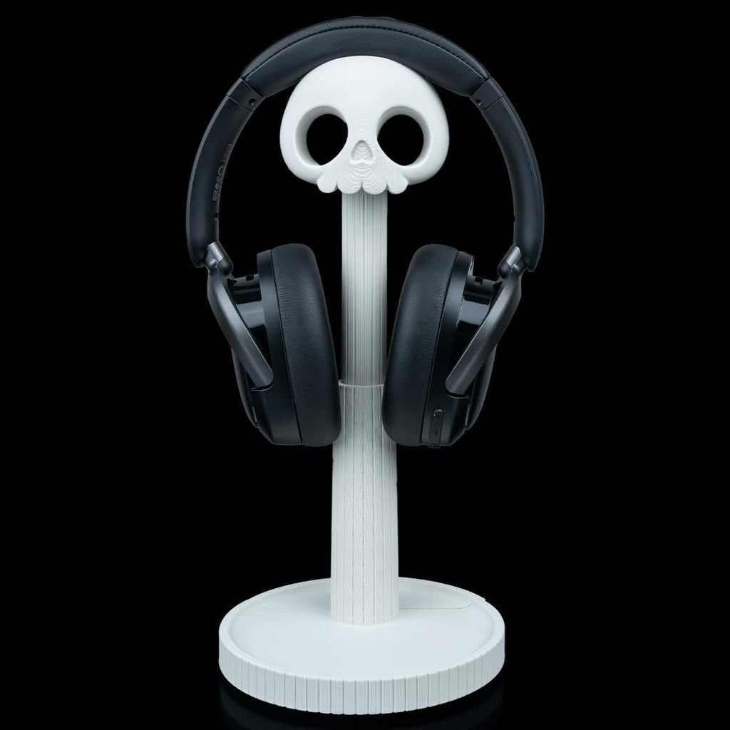 White skull headphone stand with black headphones