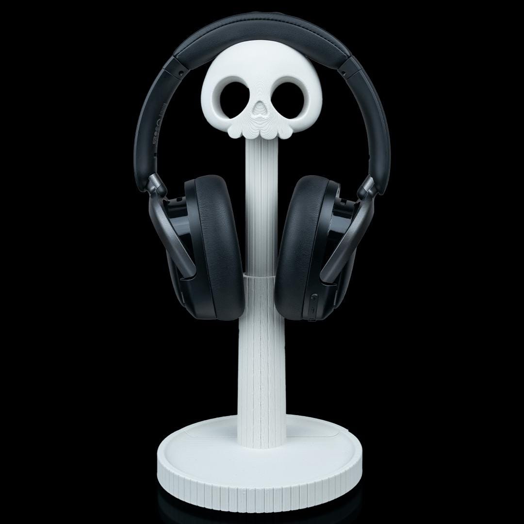White skull headphone stand with black headphones