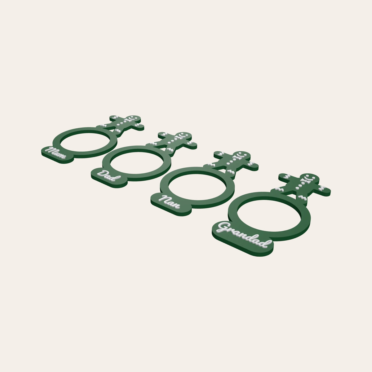 Four green napkin rings with gingerbread man toppers, each with a family name such as Mum or Grandad