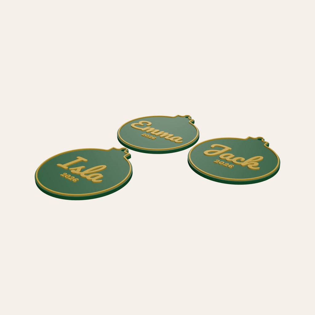 Three personalised bauble ornaments in green and gold, each with a name and the year