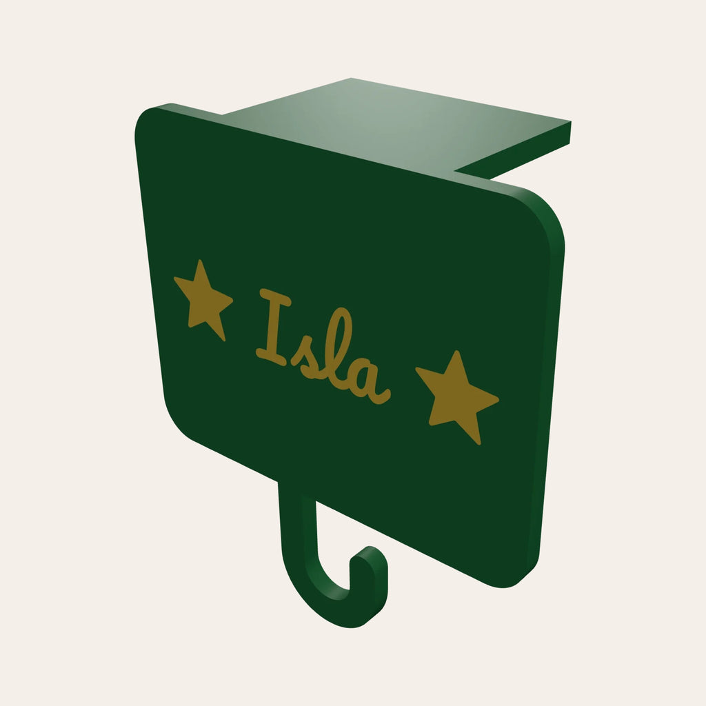 Personalised stocking holder in green and gold: a name plaque with stars, a mantel clip and a hook