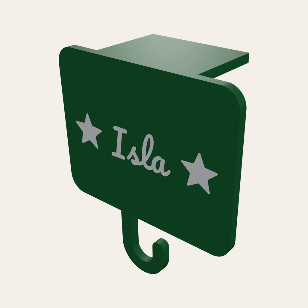 Personalised stocking holder in green and white: a name plaque with stars, a mantel clip and a hook