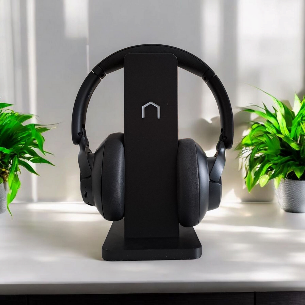 Black modern minimalist headphone holder on a clean desk