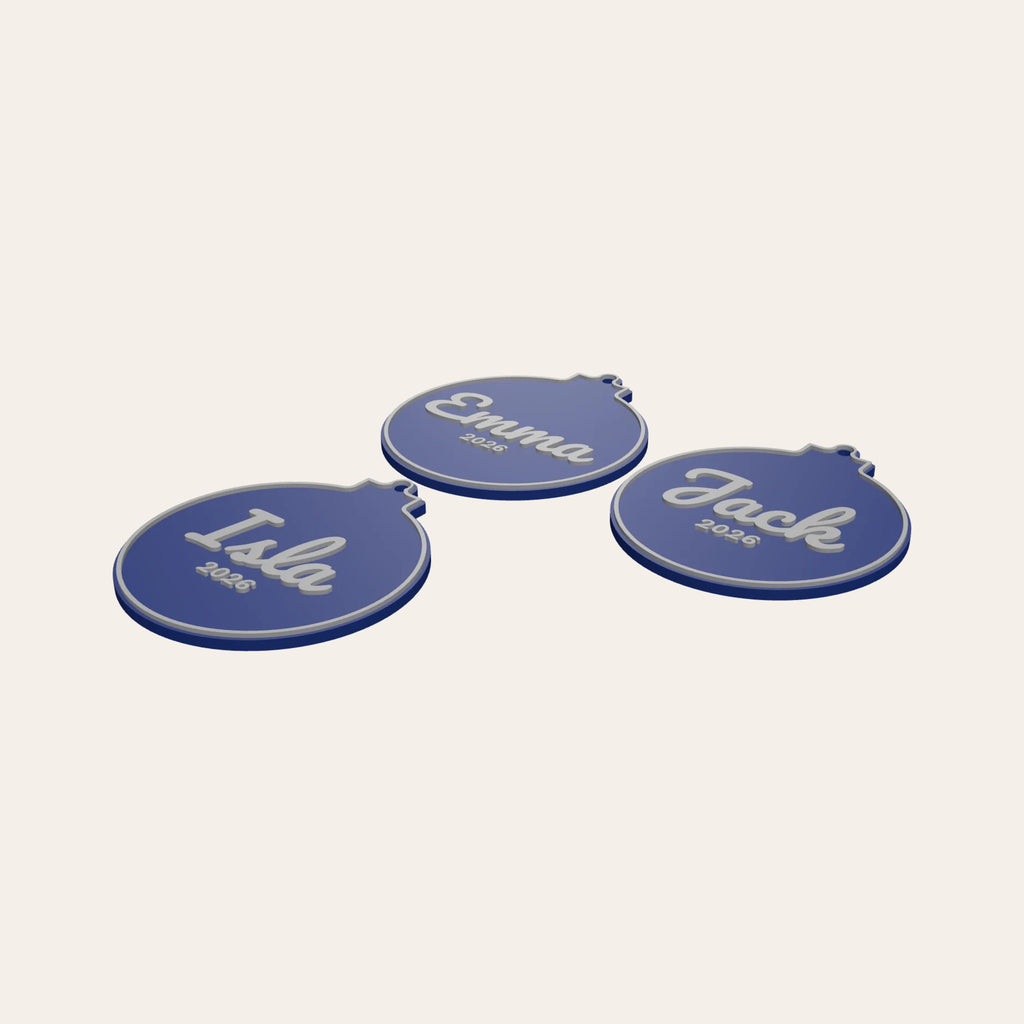 Three personalised bauble ornaments in navy and silver, each with a name and the year