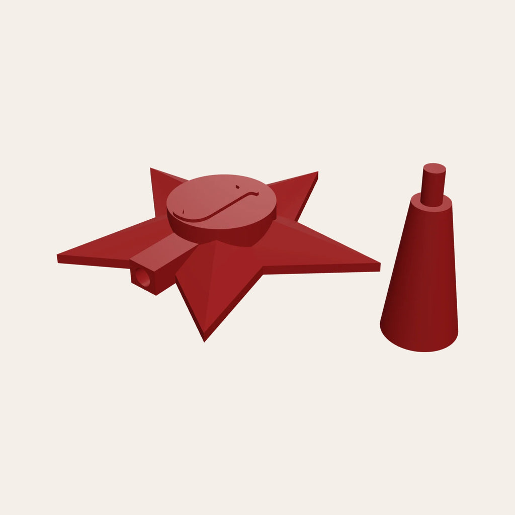 Red faceted star tree topper with a raised red initial, beside its socket